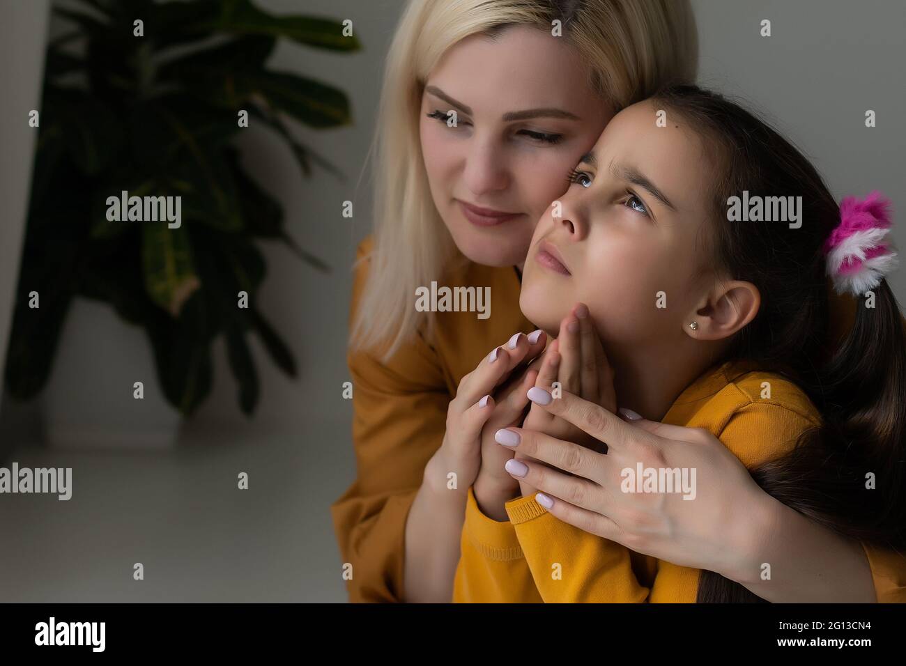 Religious Christian girl and her mother praying at home Stock Photo Alamy
