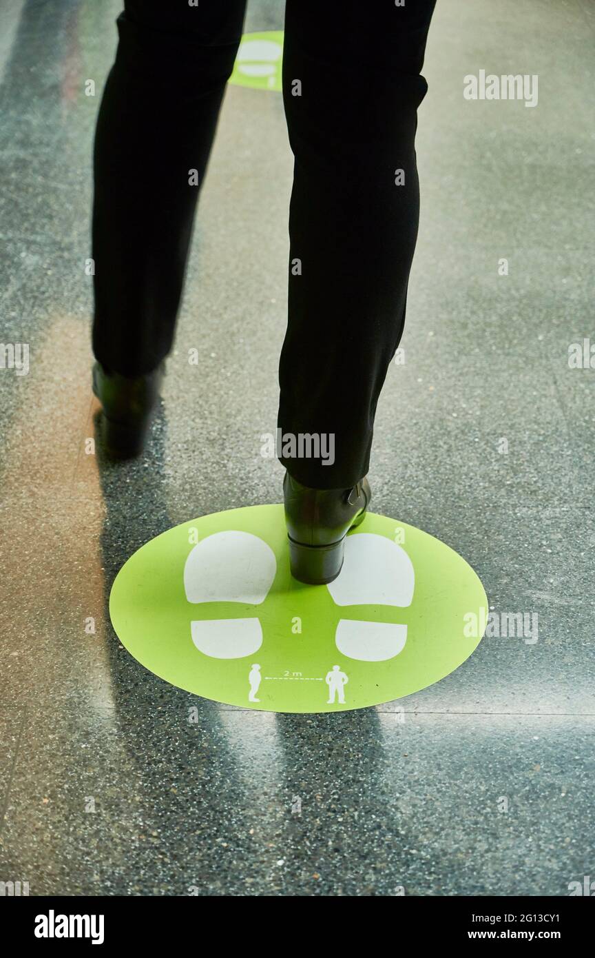 Social distance. Marking on the floor, to maintain distance between people. Legs. Stock Photo