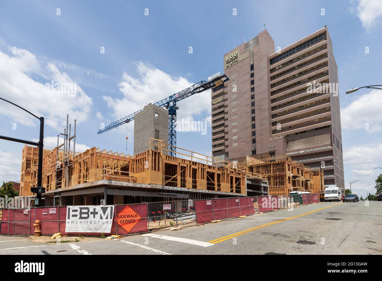WINSTON-SALEM, NC, USA-1 JUNE 2021: New construction with a crane on site on 5th St. and Poplar downtown, and the high-rise office building named 500 Stock Photo
