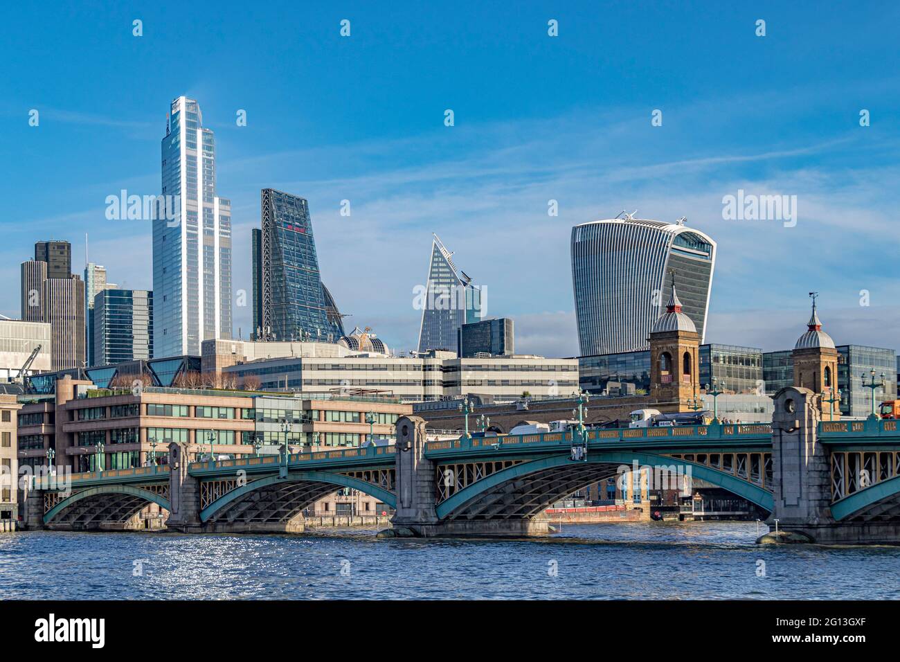 Cannon Street bridge with the high rise buildings of the City Of London in the background including the Walkie Talkie and 22 Bishopsgate, London, UK Stock Photo