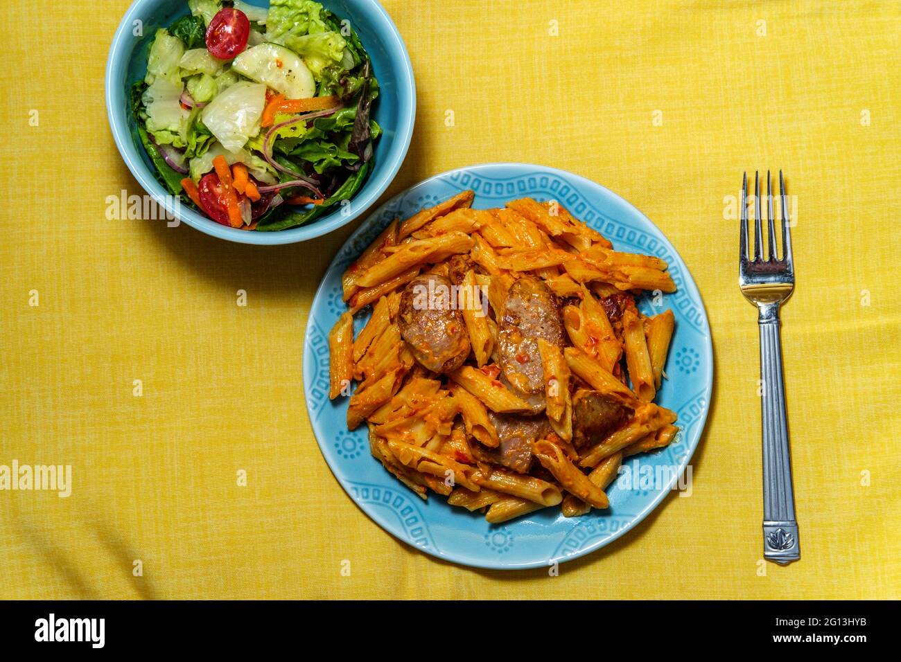 Italian penne alla vodka pink cream sauce with sliced spicy sausage and