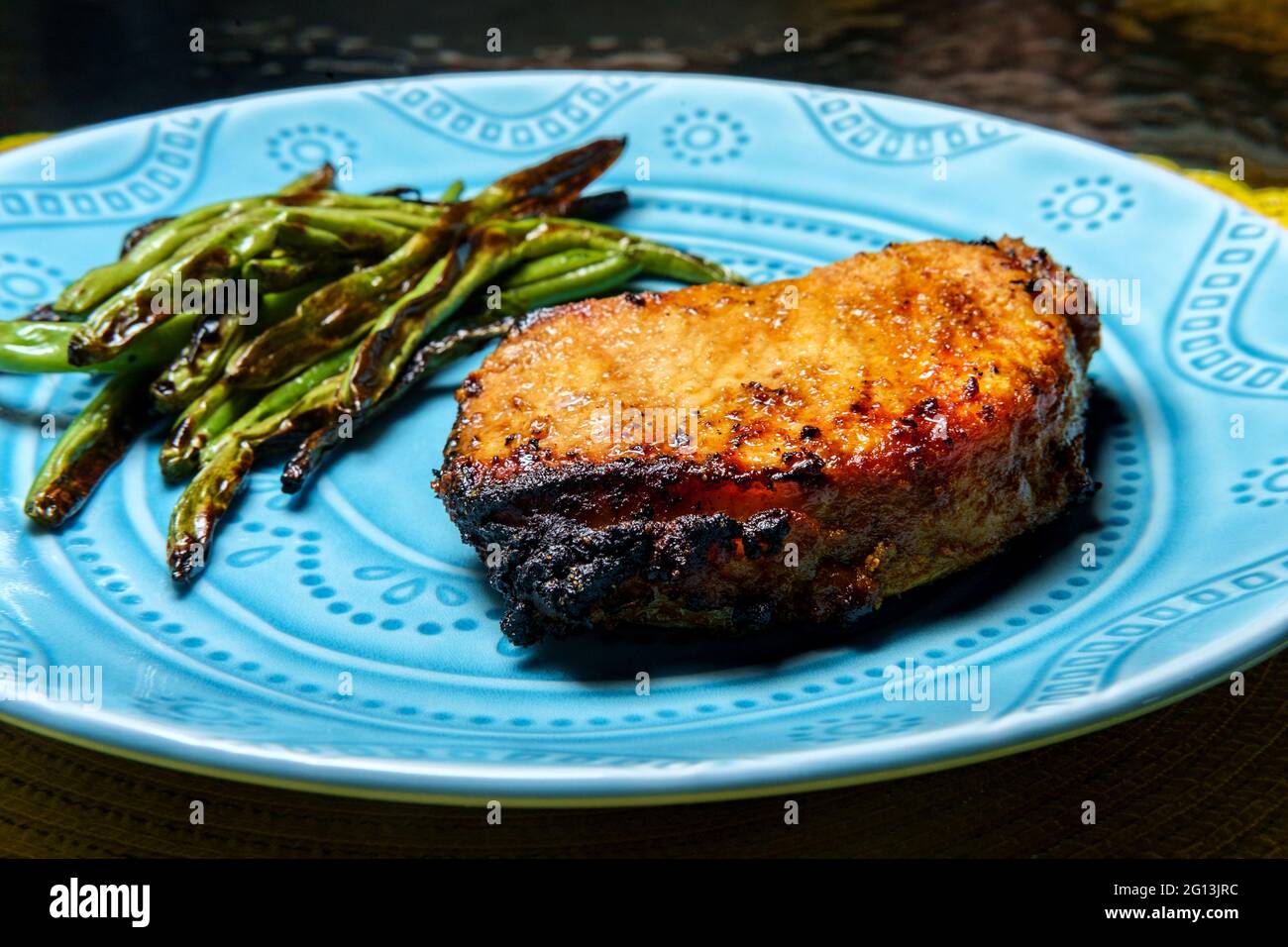 Marinated chargrilled pork chops with green beans Stock Photo Alamy