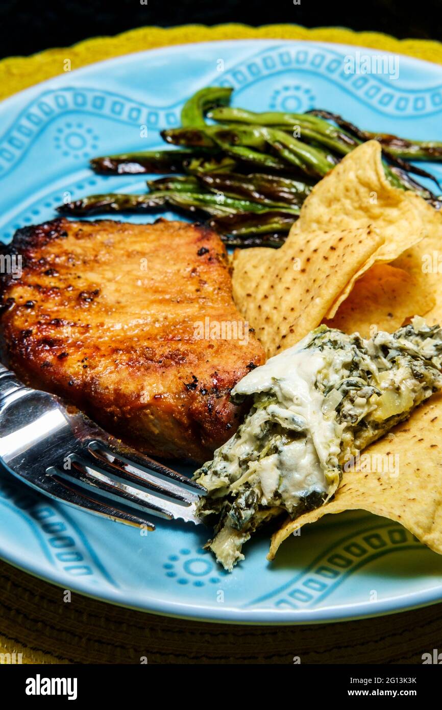 Marinated chargrilled pork chops with green beans and artichoke