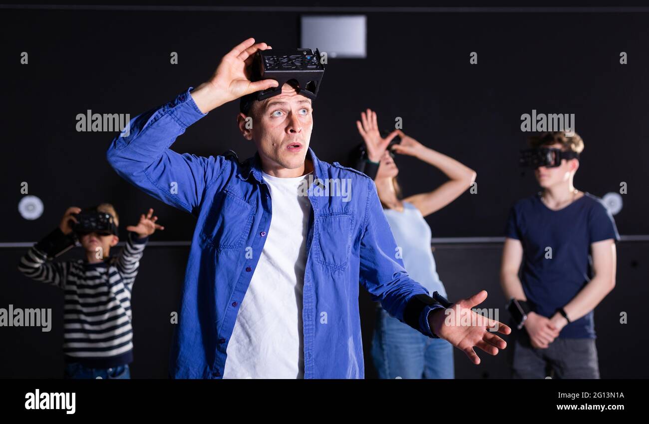 Portrait of a surprised young man who took off his virtual reality glasses Stock Photo