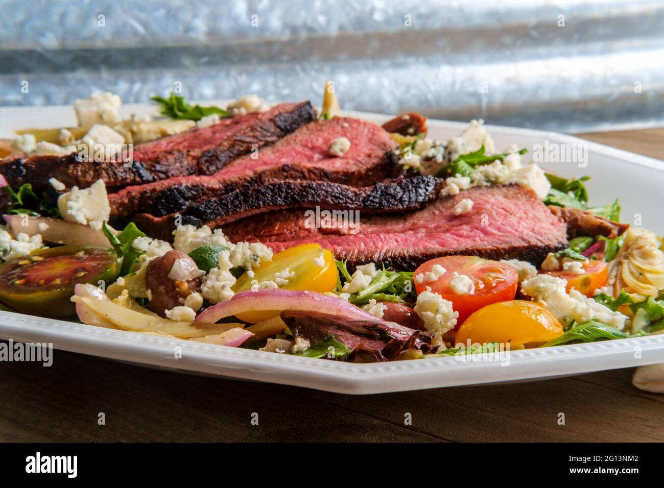 Blue cheese steak salad cooked rare with kalamata olives and artichoke