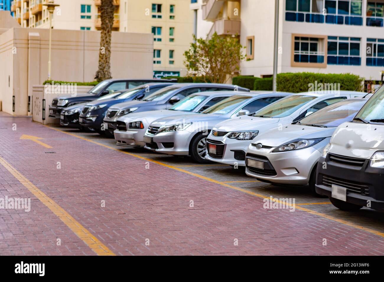 DUBAI, UAE - MARCH 2020: Cars on the parking in a street of Dubai Stock Photo