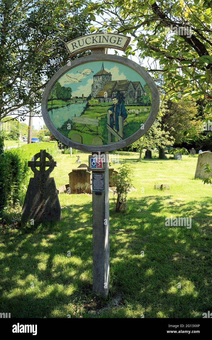 Village Millennium sign in churchyard of the church of St Mary Magdalen, Hamstreet Road, Ruckinge, Ashford, Kent, England, United Kingdom Stock Photo