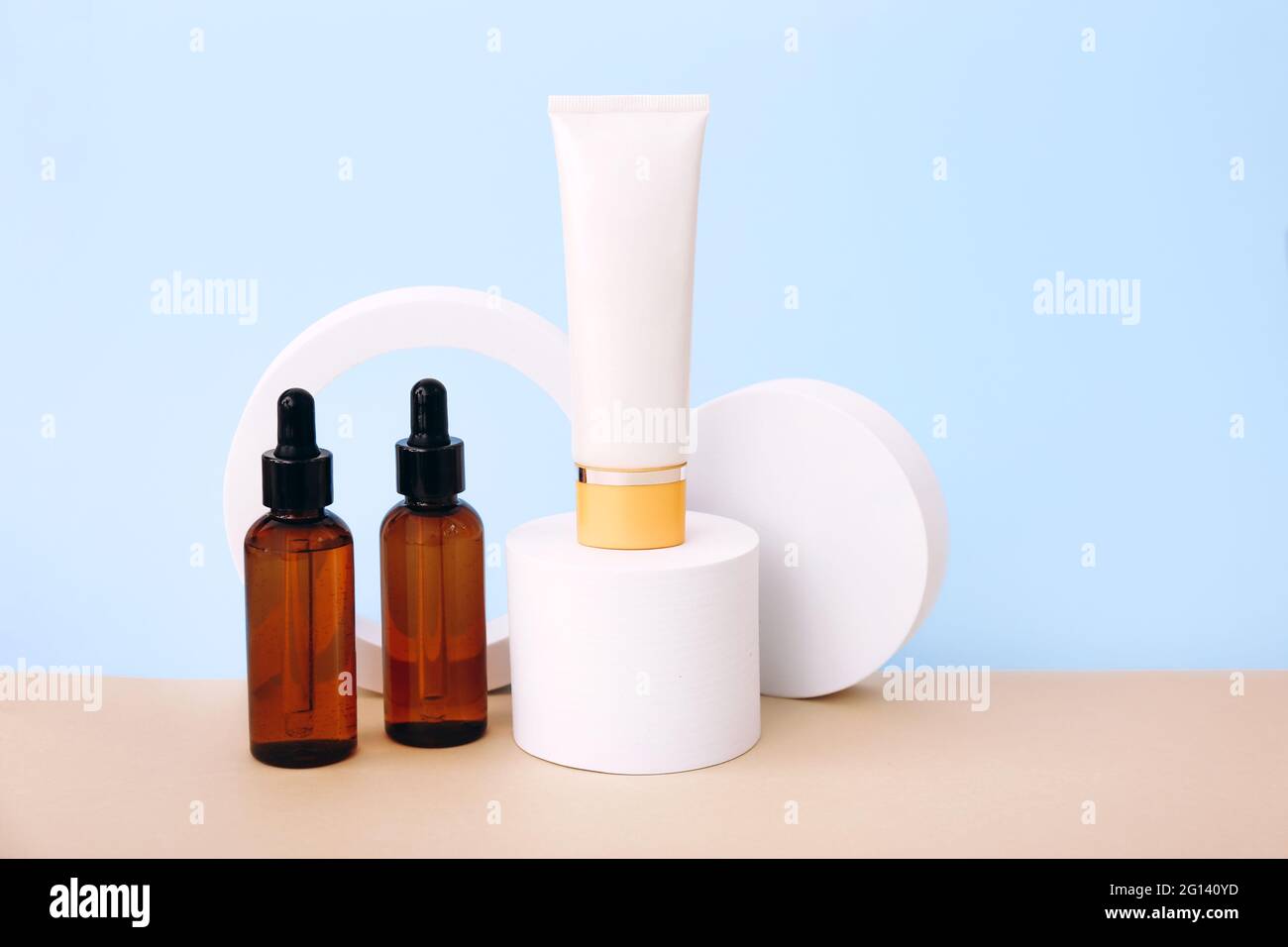 Cosmetic bottles on the geometric podiums. Presentation template for natural beauty products on beige background Stock Photo