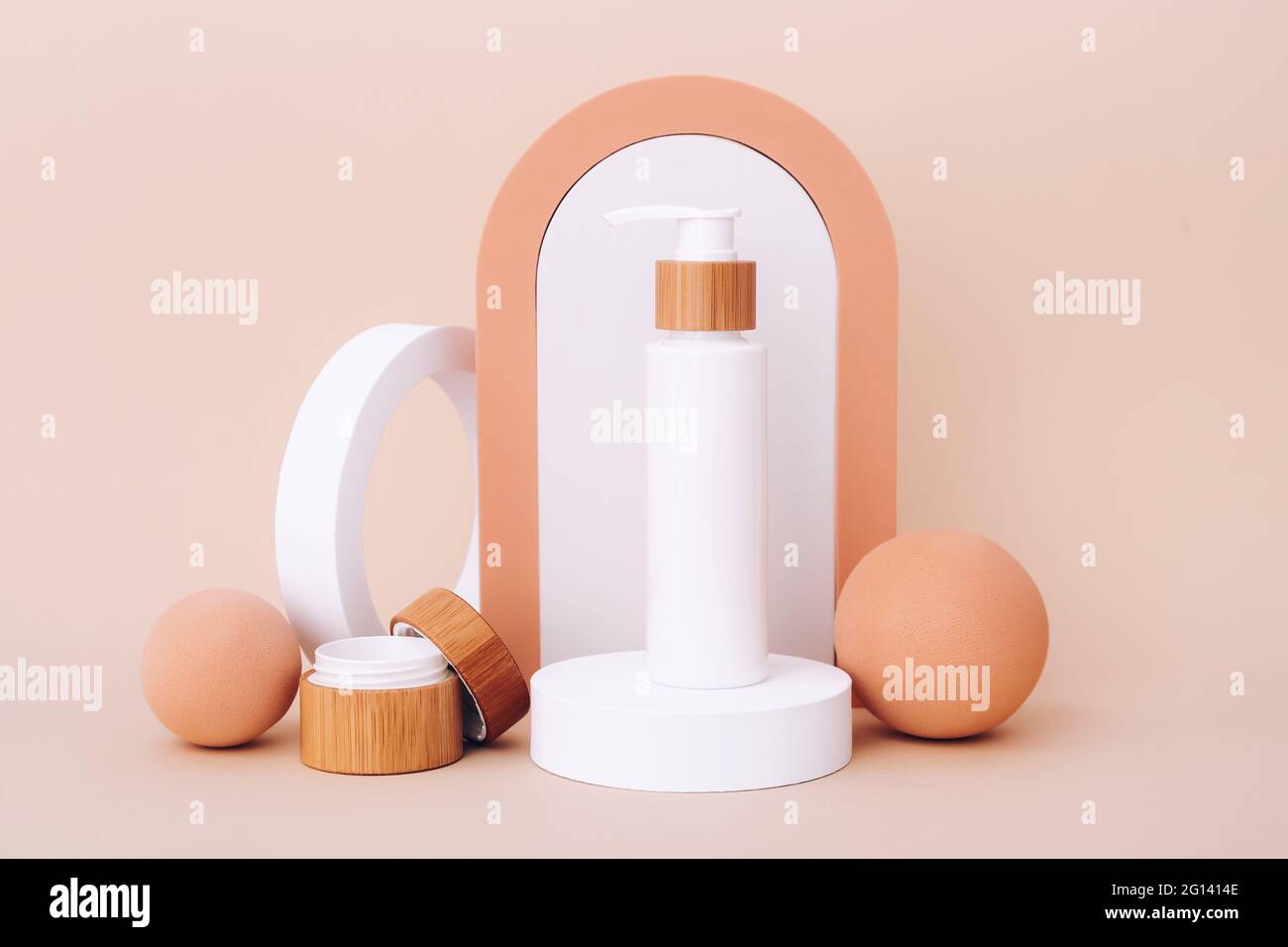 Cosmetic bottles on the geometric podiums. Presentation template for natural beauty products on beige background Stock Photo