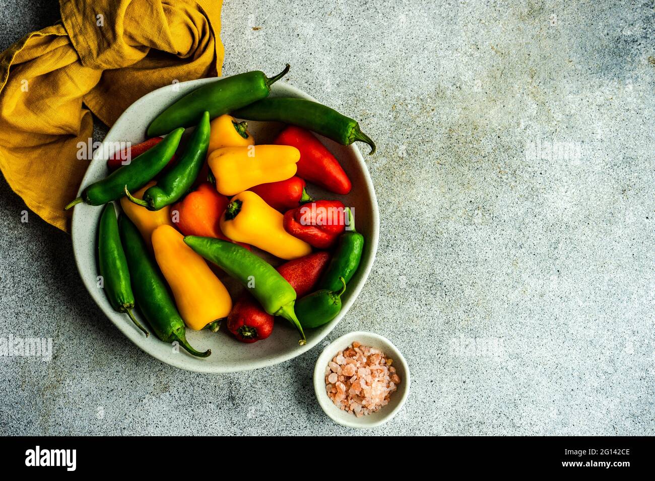 Cooking concept with gresh raw peppers on stone background Stock Photo