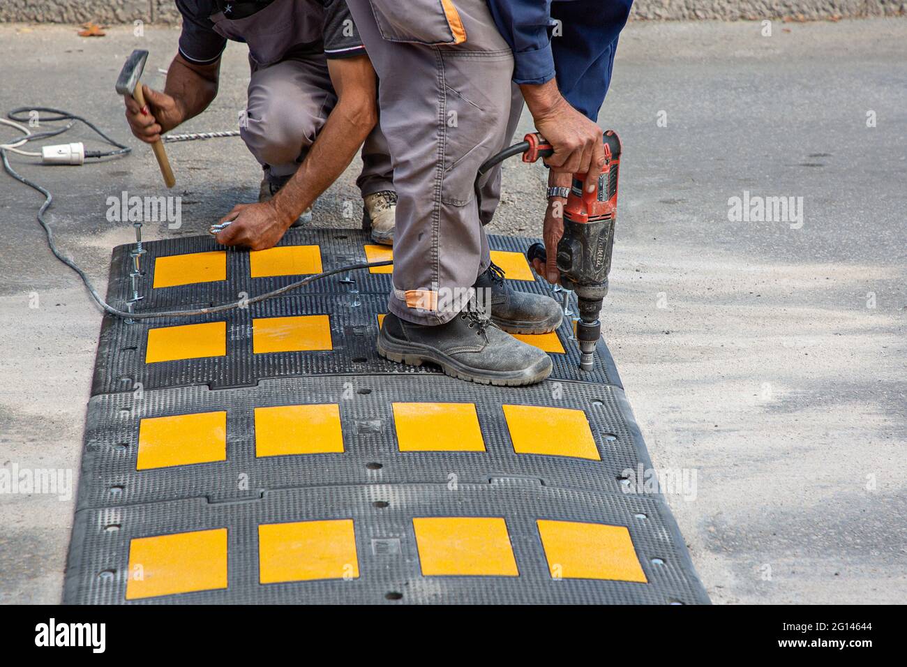 Road workers putting speed bumps in Bosnia and Herzegovina Stock Photo