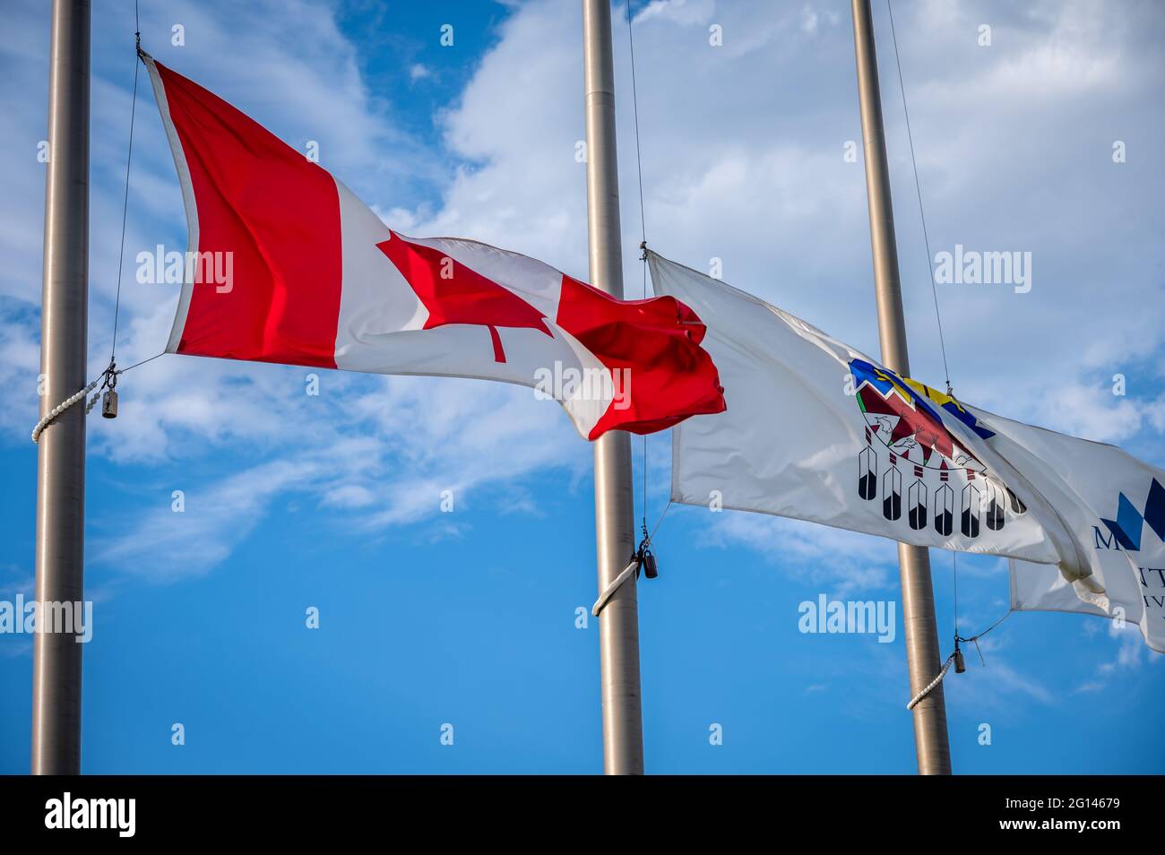 Canadian and Treaty 7 flags flying at half mast Stock Photo Alamy