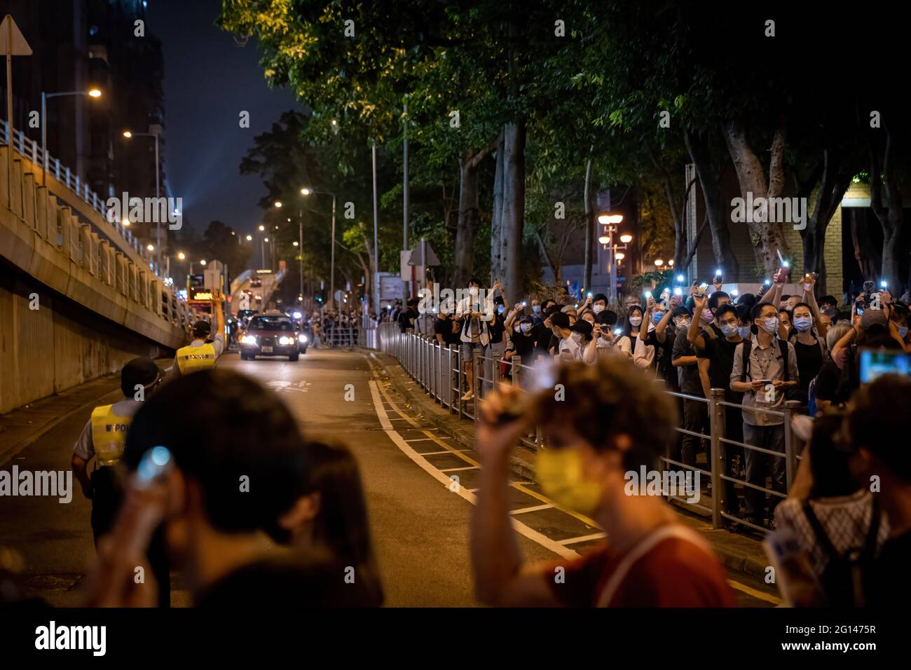 Hong Kong, China. 04th June, 2021. People flashing their mobile phones as part of the small protests by Hong Kong people during the anniversary. Police blocked off Hong Kong Victoria Park to prevent people gathering to commemorate the 32nd anniversary of China's 1989 Tiananmen Square crackdown and arrested the planned vigil organisers. Credit: SOPA Images Limited/Alamy Live News Stock Photo
