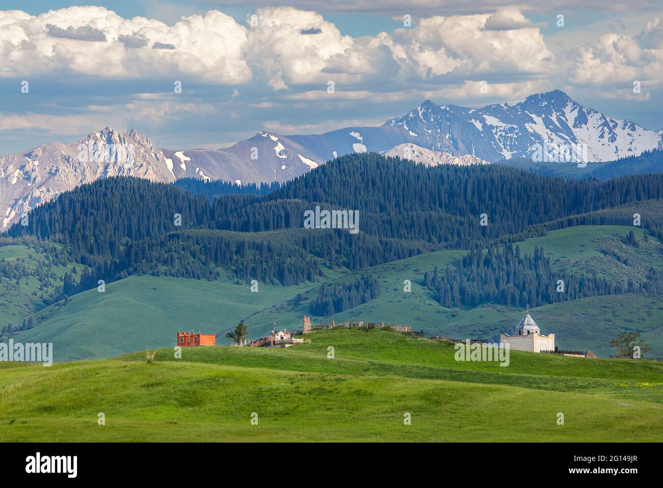 Central Asian muslim cemetery with mountain backdrops in Kazakhstan Stock Photo