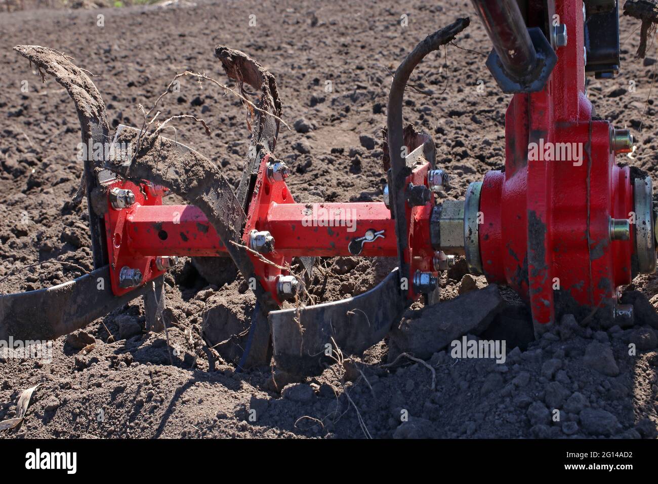 Garden tiller for cultivating field, loosens soil. Handheld motor plow