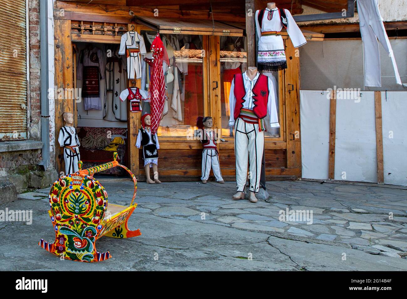 Shop selling national costumes of Kosovo on cobblestone street, in Gjakova, Kosovo. Stock Photo