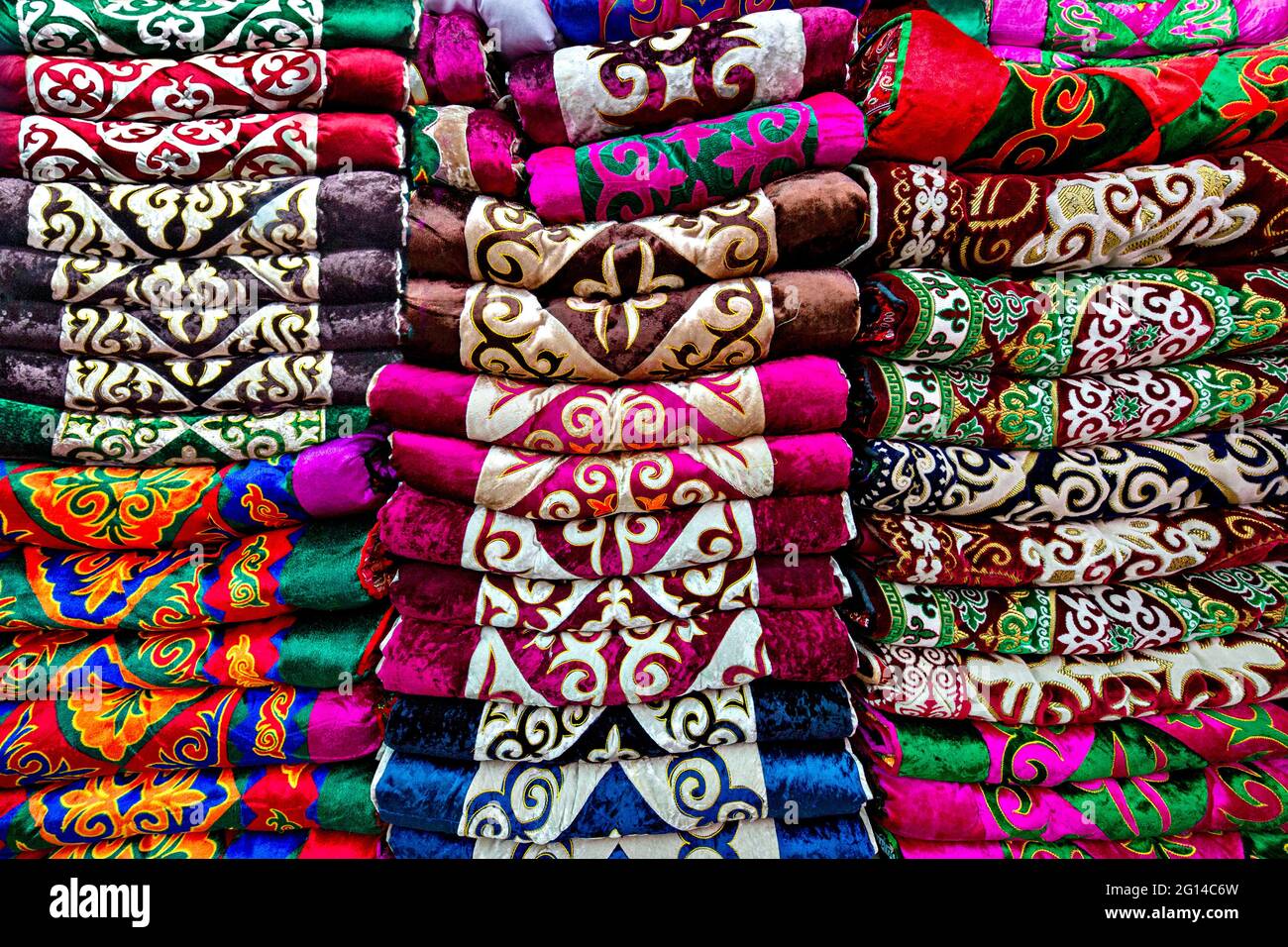 Stack of colorful textiles with traditional motifs, Bishkek, Kyrgyzstan Stock Photo