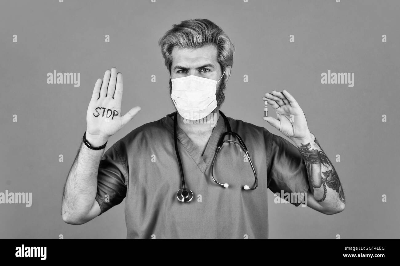 Open palm stop gesture. Epidemic threshold. Man in medical lab. Protective mask. Stop epidemic. Virus concept. Danger zone. Epidemic infection Stock Photo