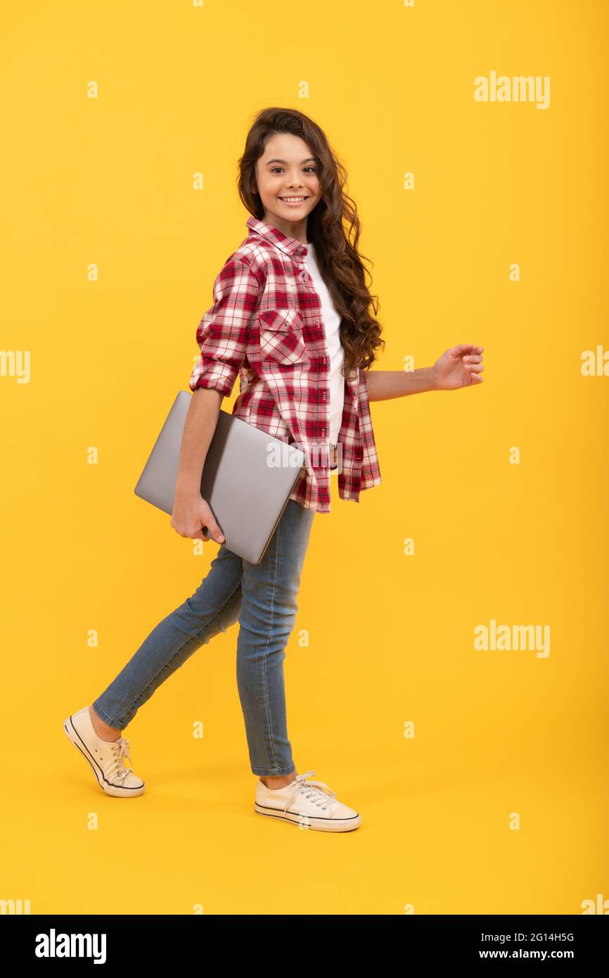 A next-level school. Happy girl child carry laptop. E-learning course. Online course Stock Photo