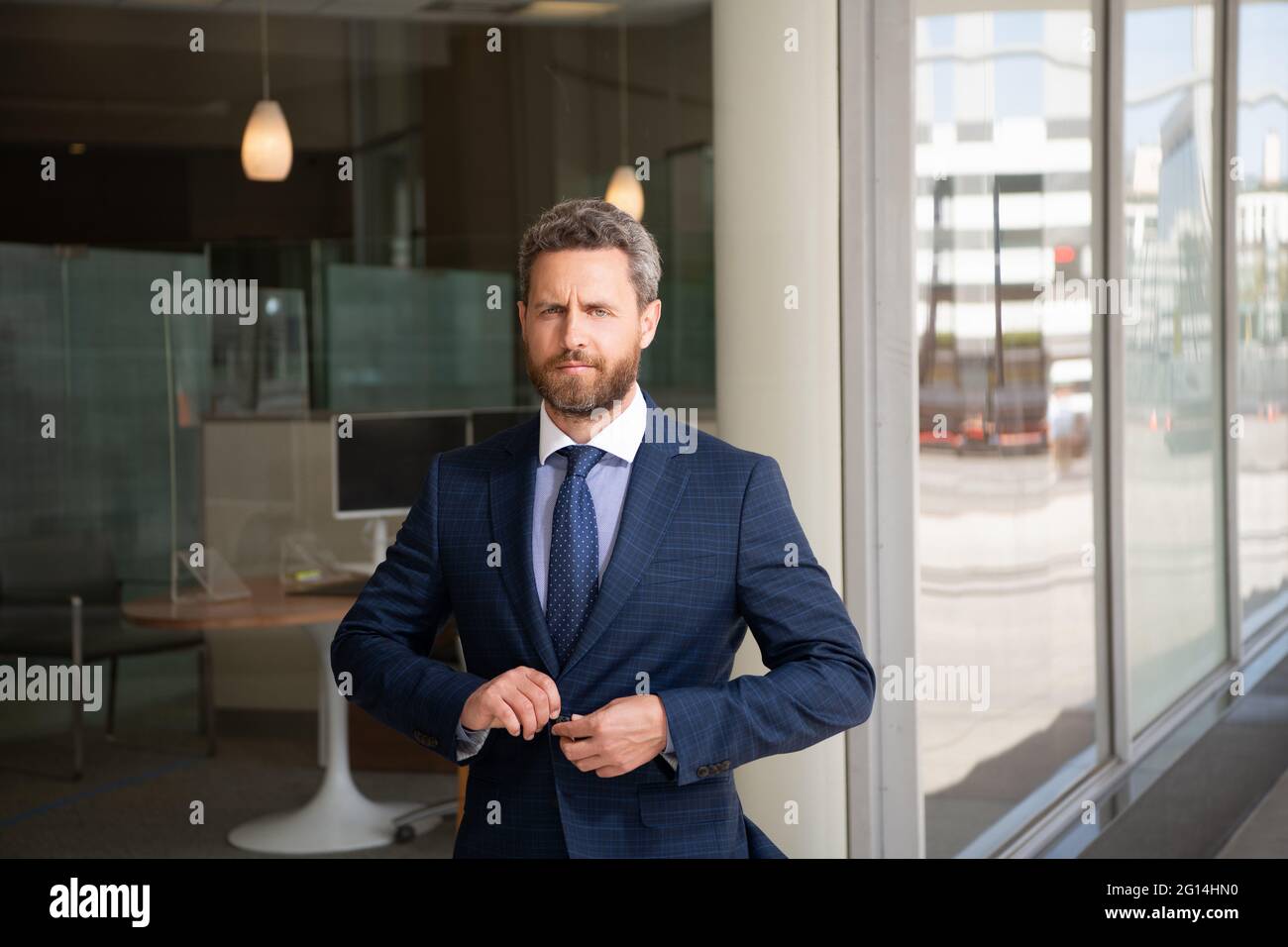man businessman in businesslike suit at business office, business success Stock Photo