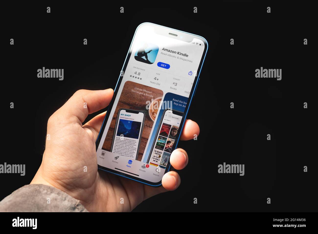 Kharkov, Ukraine - June 4, 2021: Amazon kindle app, man holds mobile phone with application on screen Stock Photo