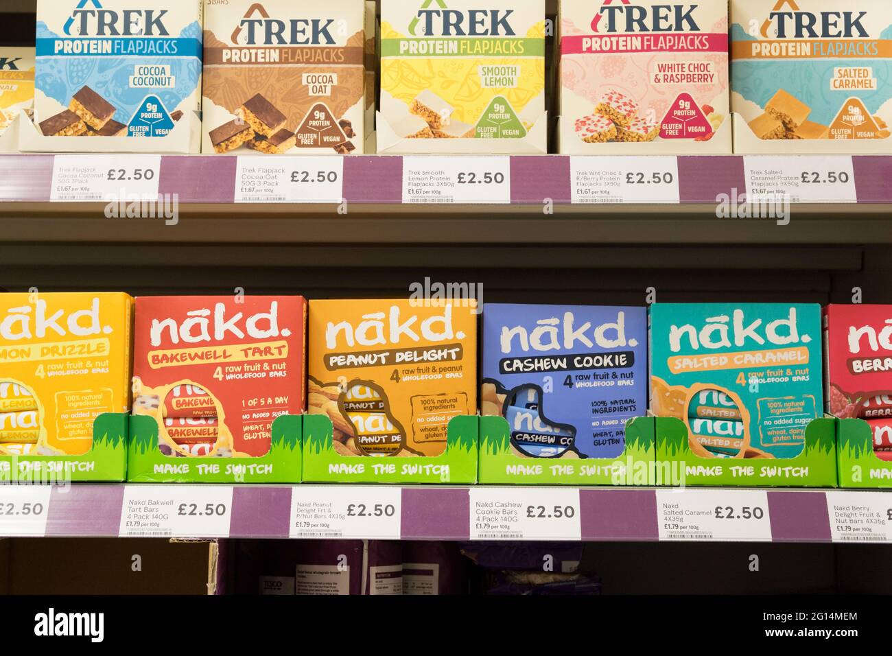 boxes of Trek and NAKD snack bar, protein bars for sale on shelves at
