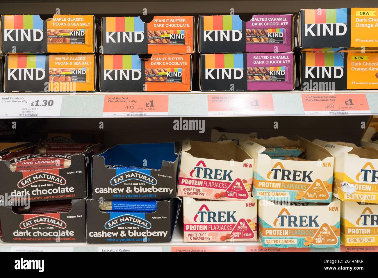 KIND and TREK protein bars in boxes display on shelves for sale at