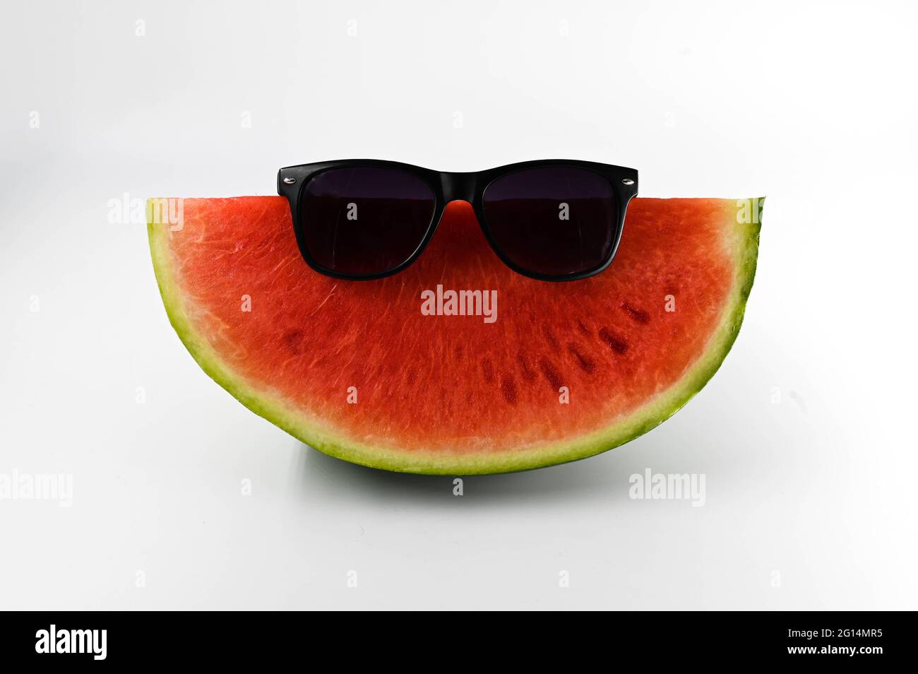 Watermelon slice with sunglasses (funny) on isolated white background