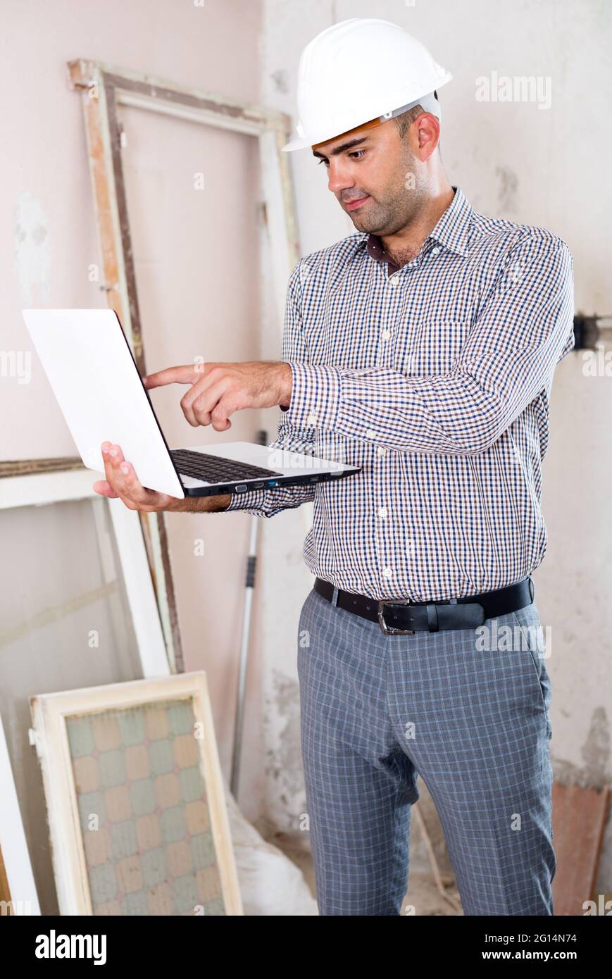 Man engineer managing process with laptop Stock Photo