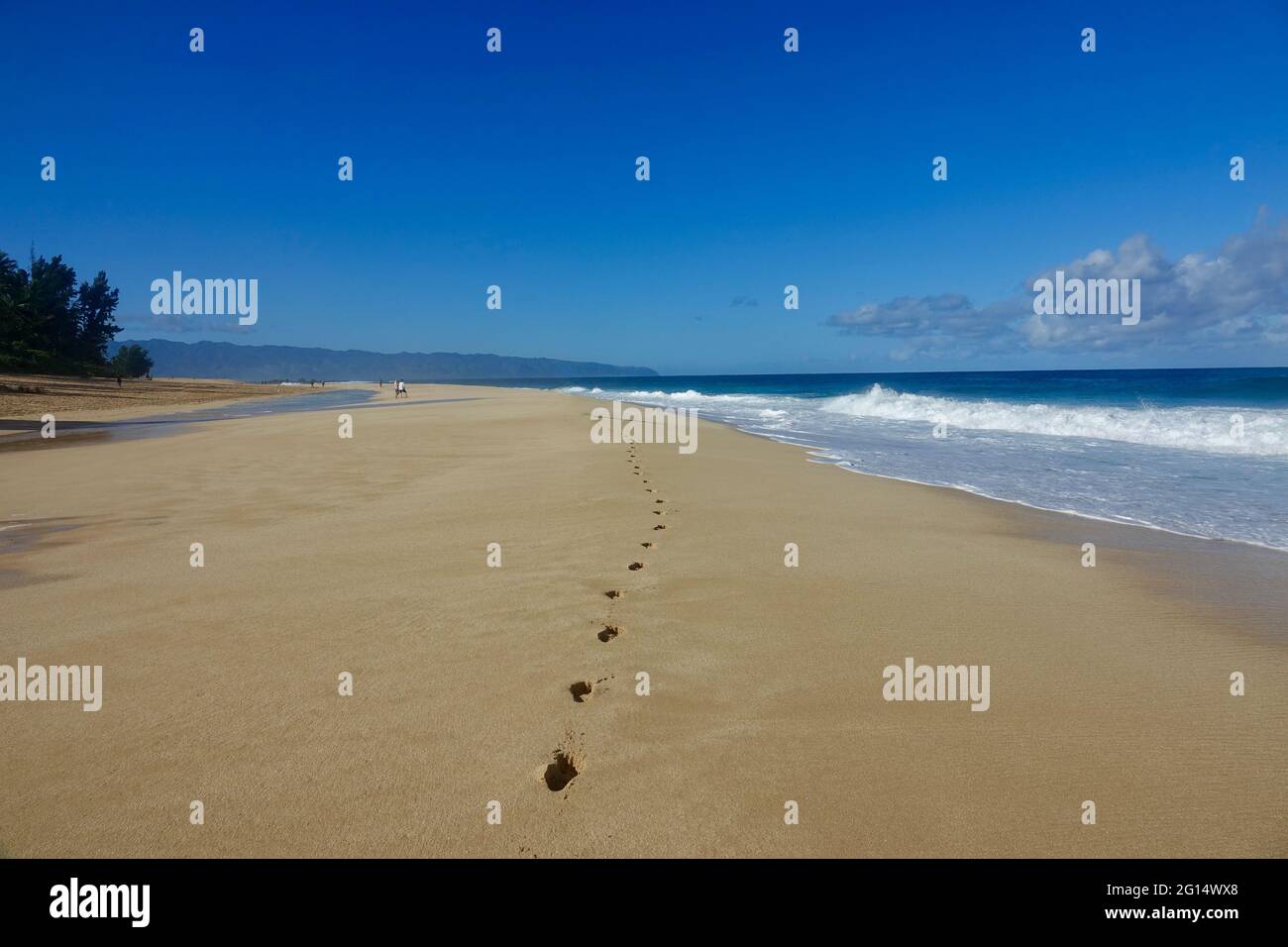 deep footsteps in the sand of a deserted island Stock Photo