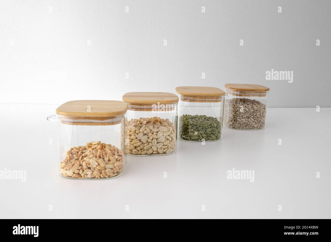 Storing nuts in glass jars on a white background. Food storage. Glass containers Stock Photo Alamy