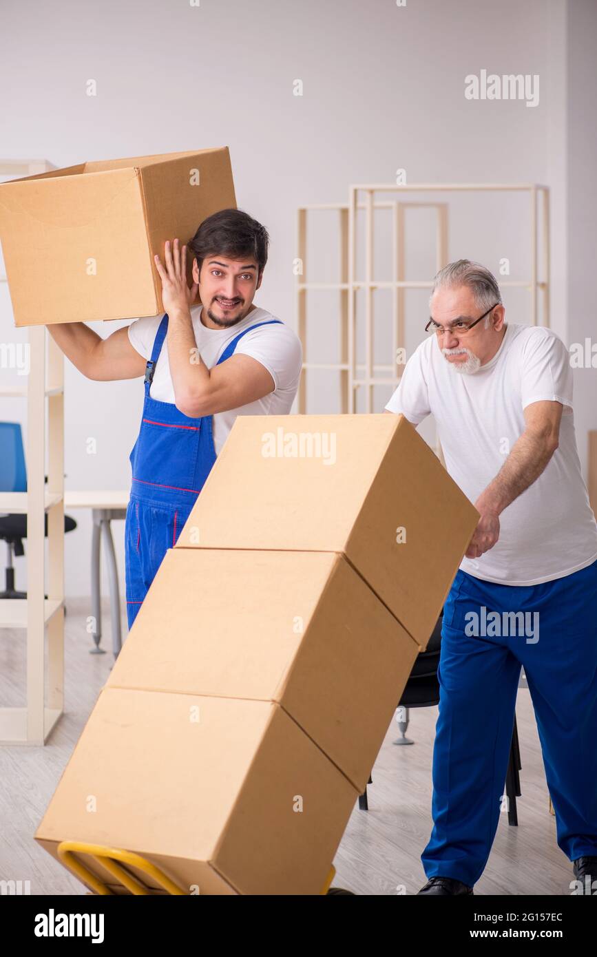 Two professional movers doing home relocation Stock Photo