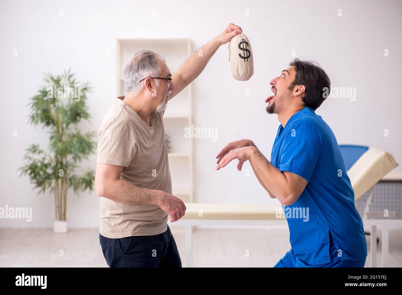 Old patient meeting young male doctor in expensive medicine concept Stock Photo