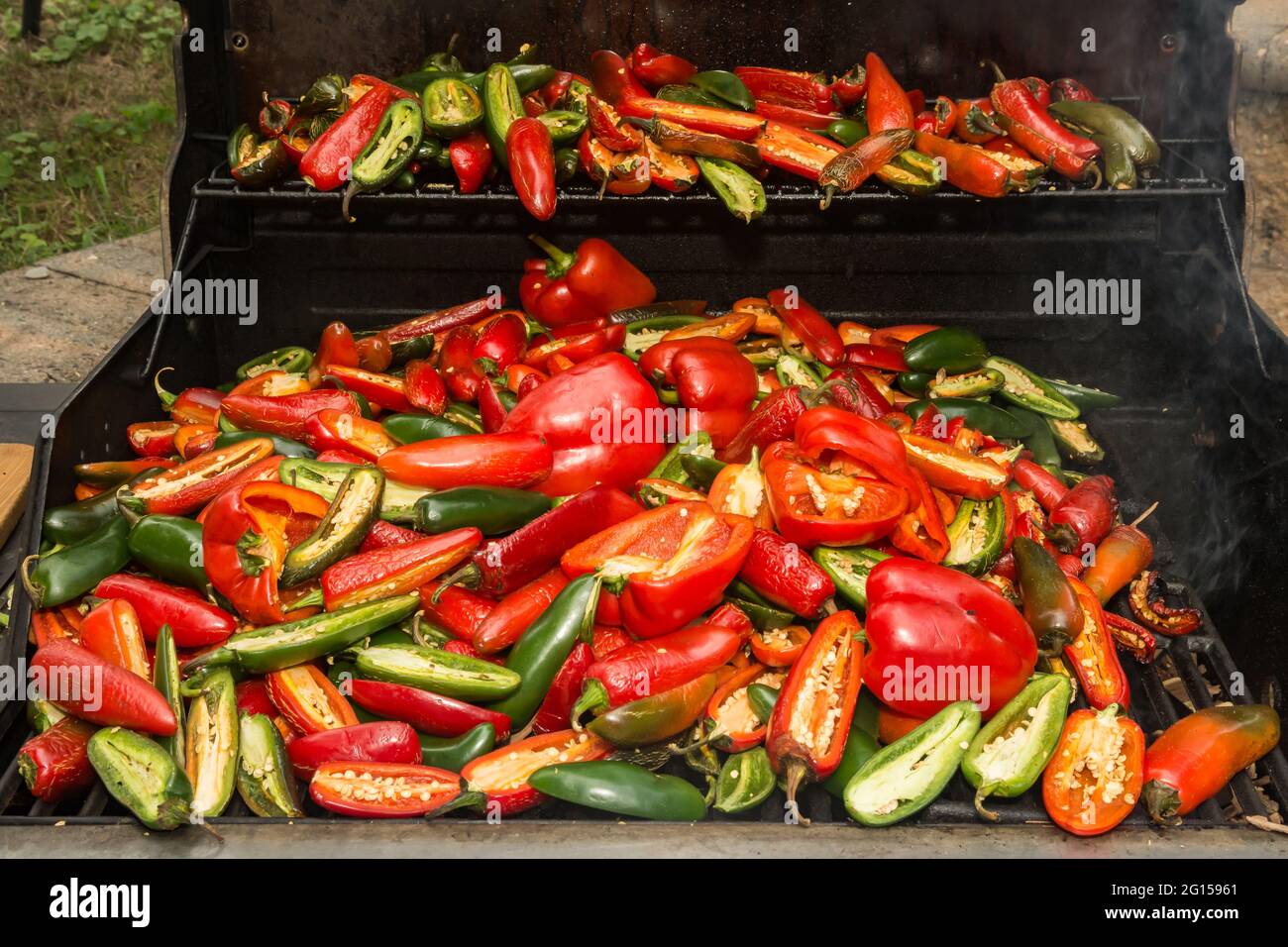 Smoking Peppers to make Homemade Sriracha Sauce. Stock Photo