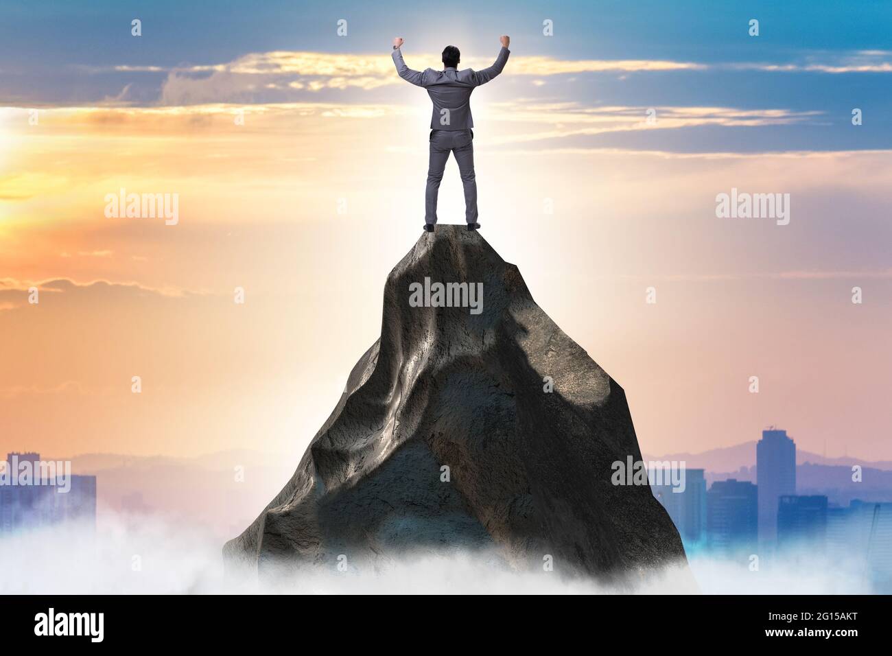 Businessman at the top of mountain in the career concept Stock Photo ...