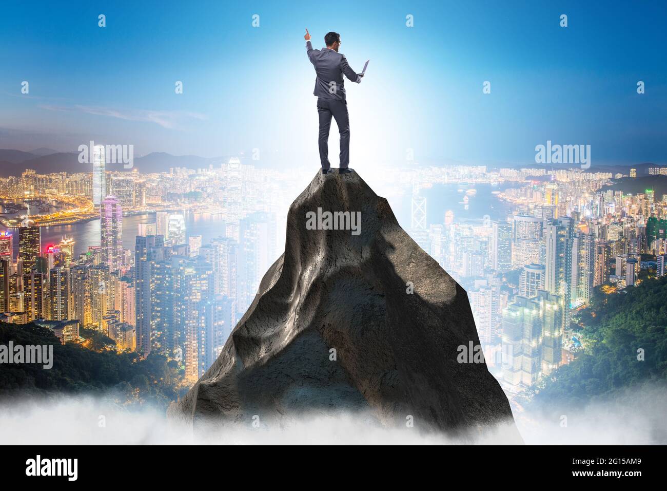 Businessman at the top of mountain in the career concept Stock Photo ...