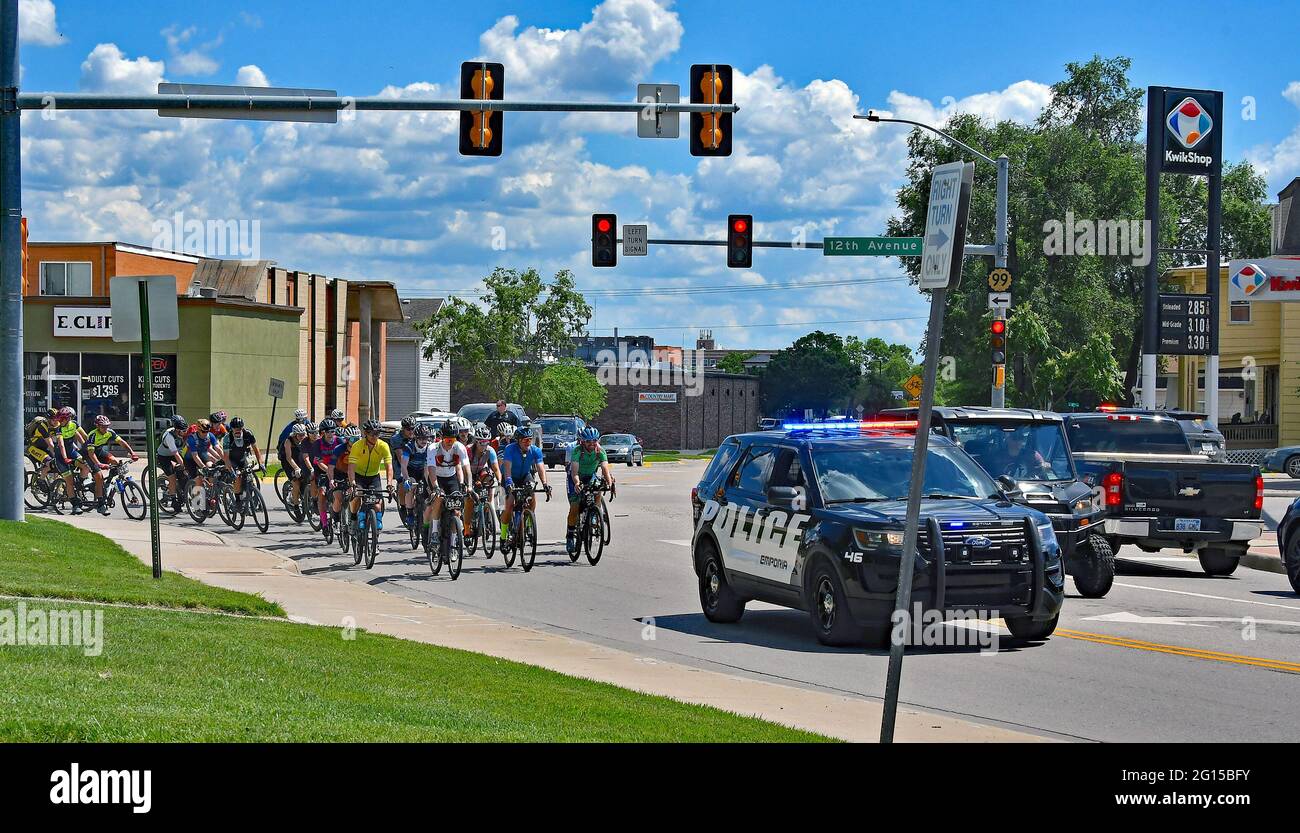 The first of 2 bike races of the Unbound XL Gravel makes the hairpin turn onto Rt 99 from 12th street at the edge of Emporia State University in downtown Emporia today. Stock Photo