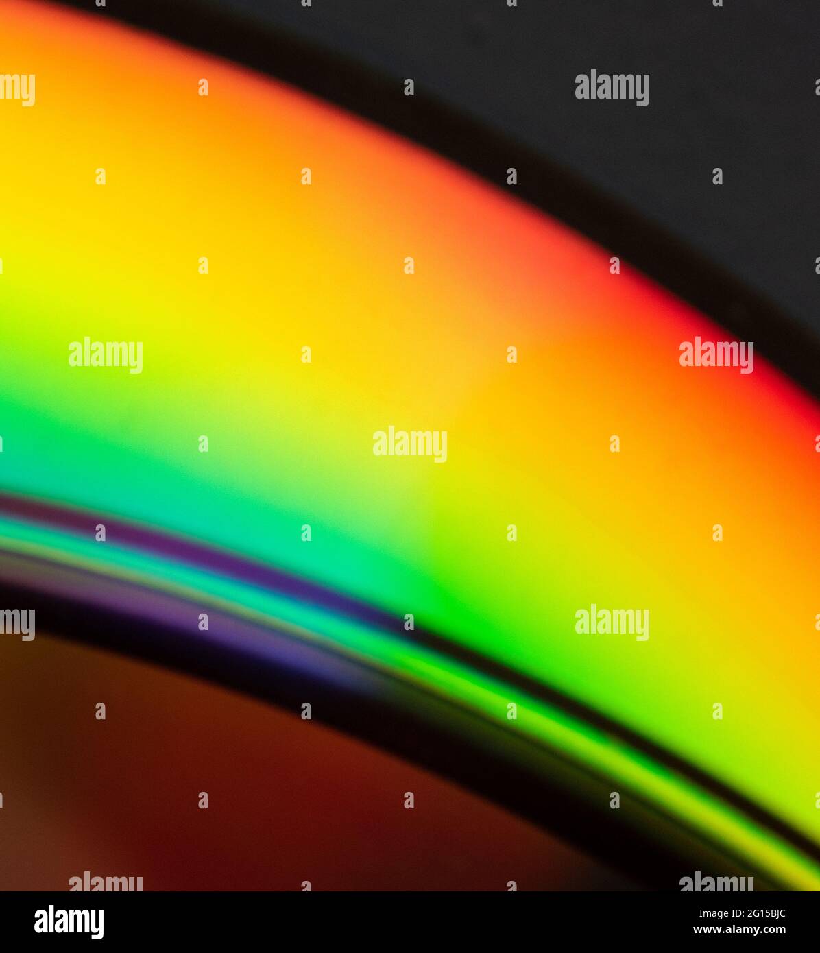 Abstract photo of the reflection of the bottom of a CD displaying a wide array of colors on its shiny film surface. Photos of different angles produci Stock Photo
