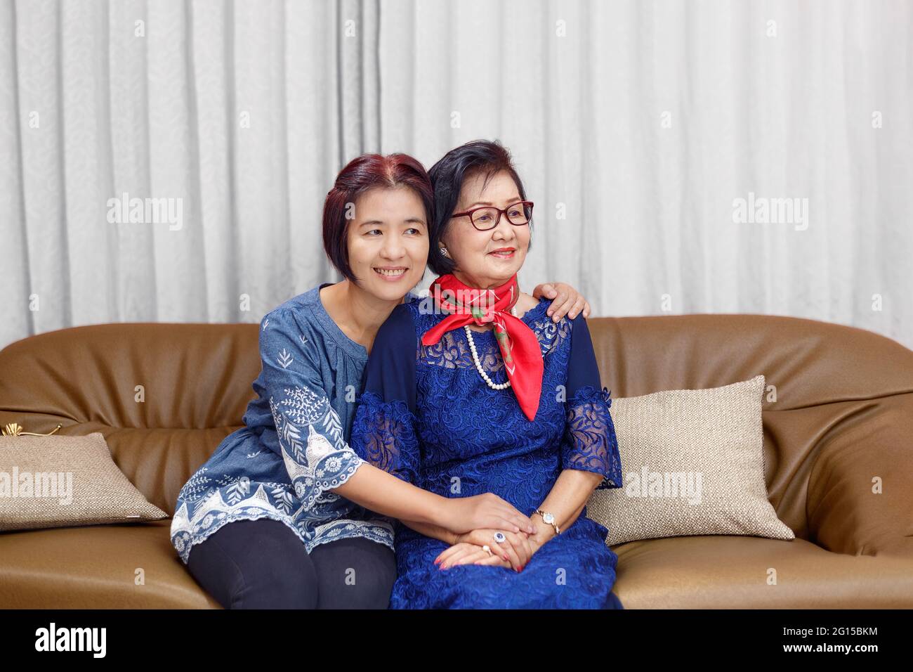 Mature daughter coming home and hug mother on the mother's day Stock Photo