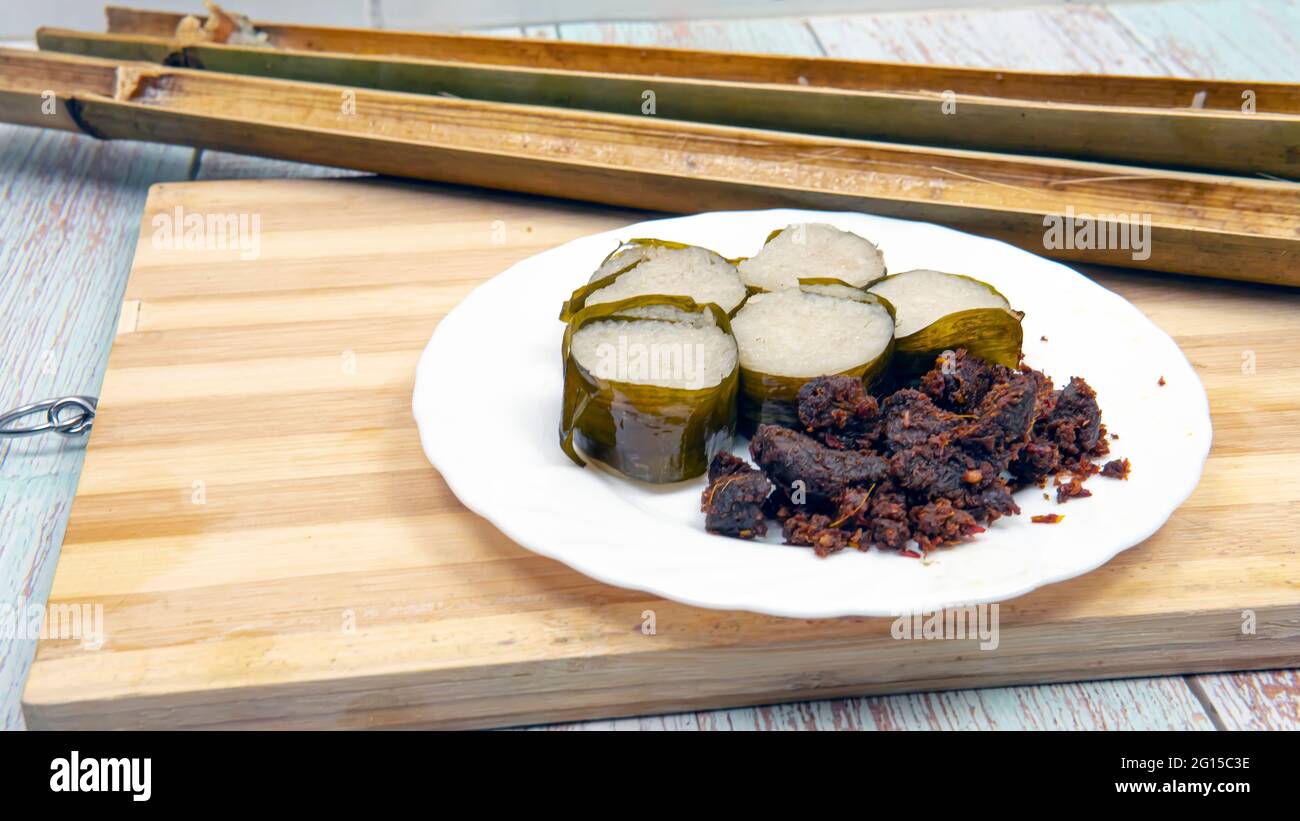 Selective focus of  glutinous rice is wrapped with lerek or banana leaf encased in bamboo culm and cooked in open fire or known in malays as 'Lemang' Stock Photo