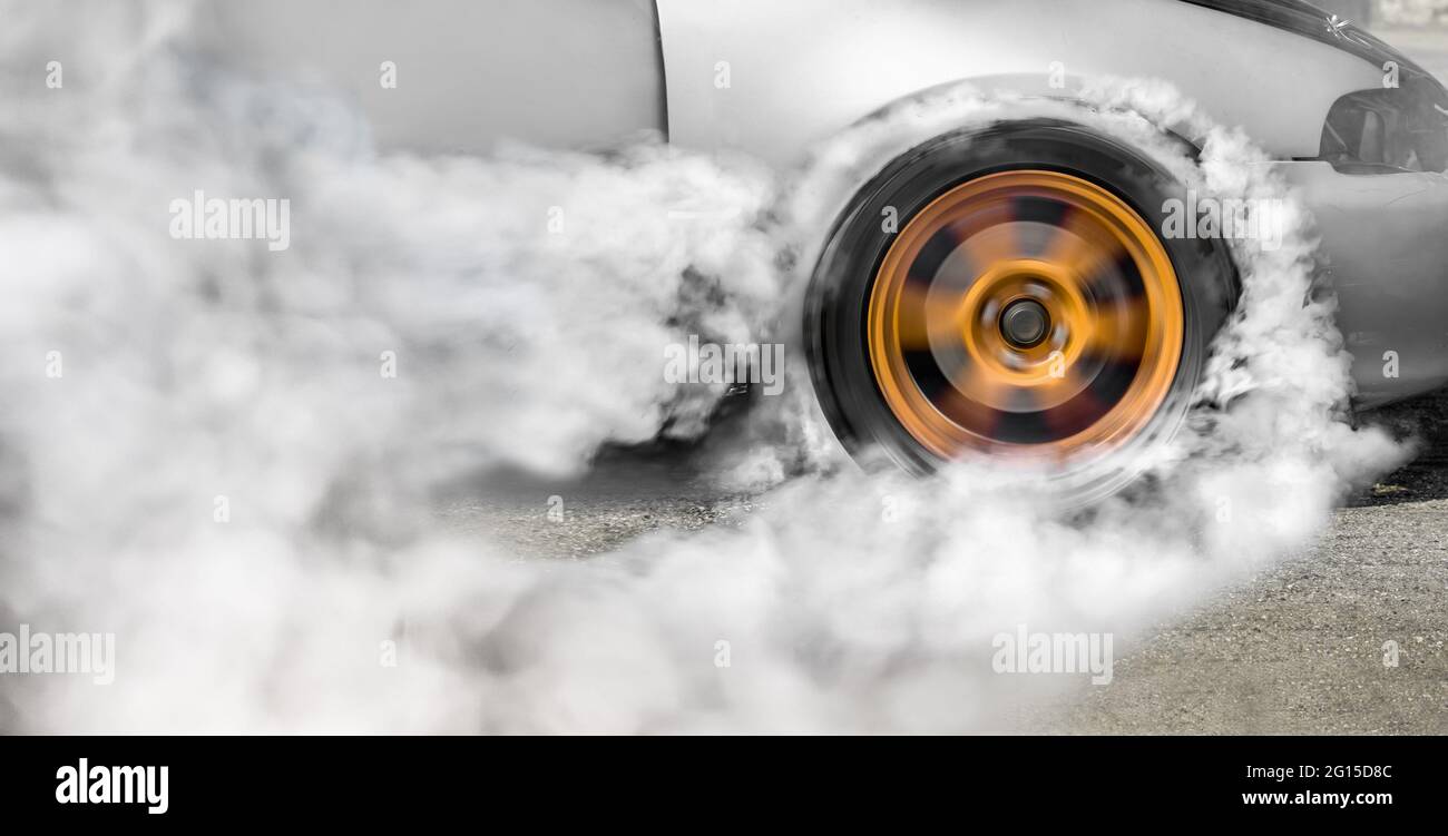 Drag racing car burns rubber off its tires in preparation for the race ...