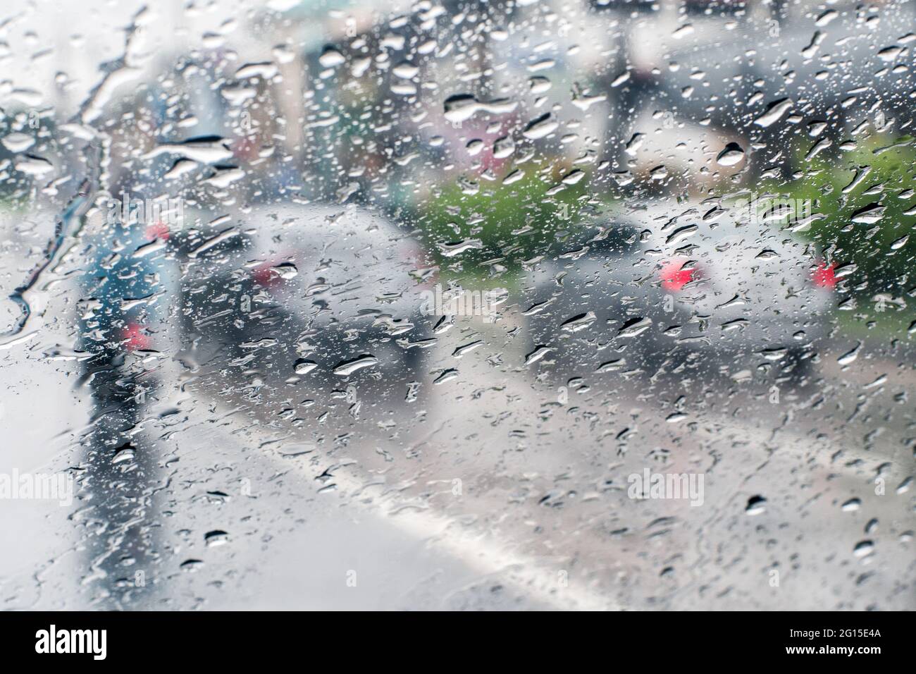Raindrops on windshield from inside the car in traffic jam Stock Photo