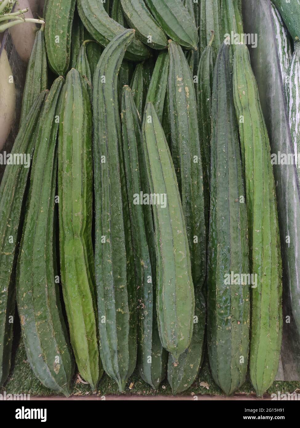 Chinese okra is tender; the bright white flesh has spongy texture and offers a silky, subtly sweet flavor when cooked. As it matures, the skin becomes Stock Photo