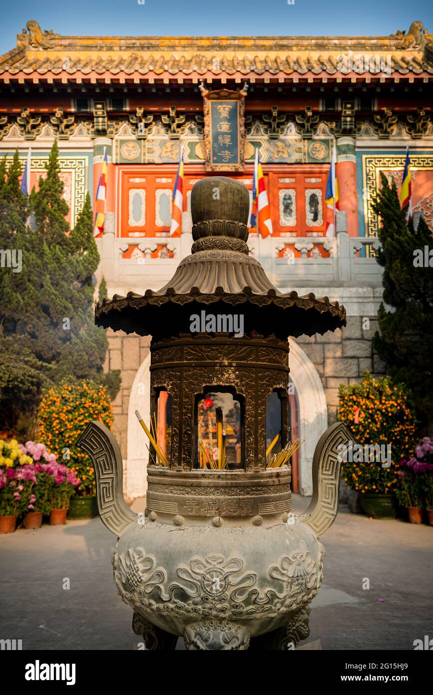 Iron censer and entrance gate to the Po Lin Buddhist monastery, Lantau Island, Hong Kong Stock Photo