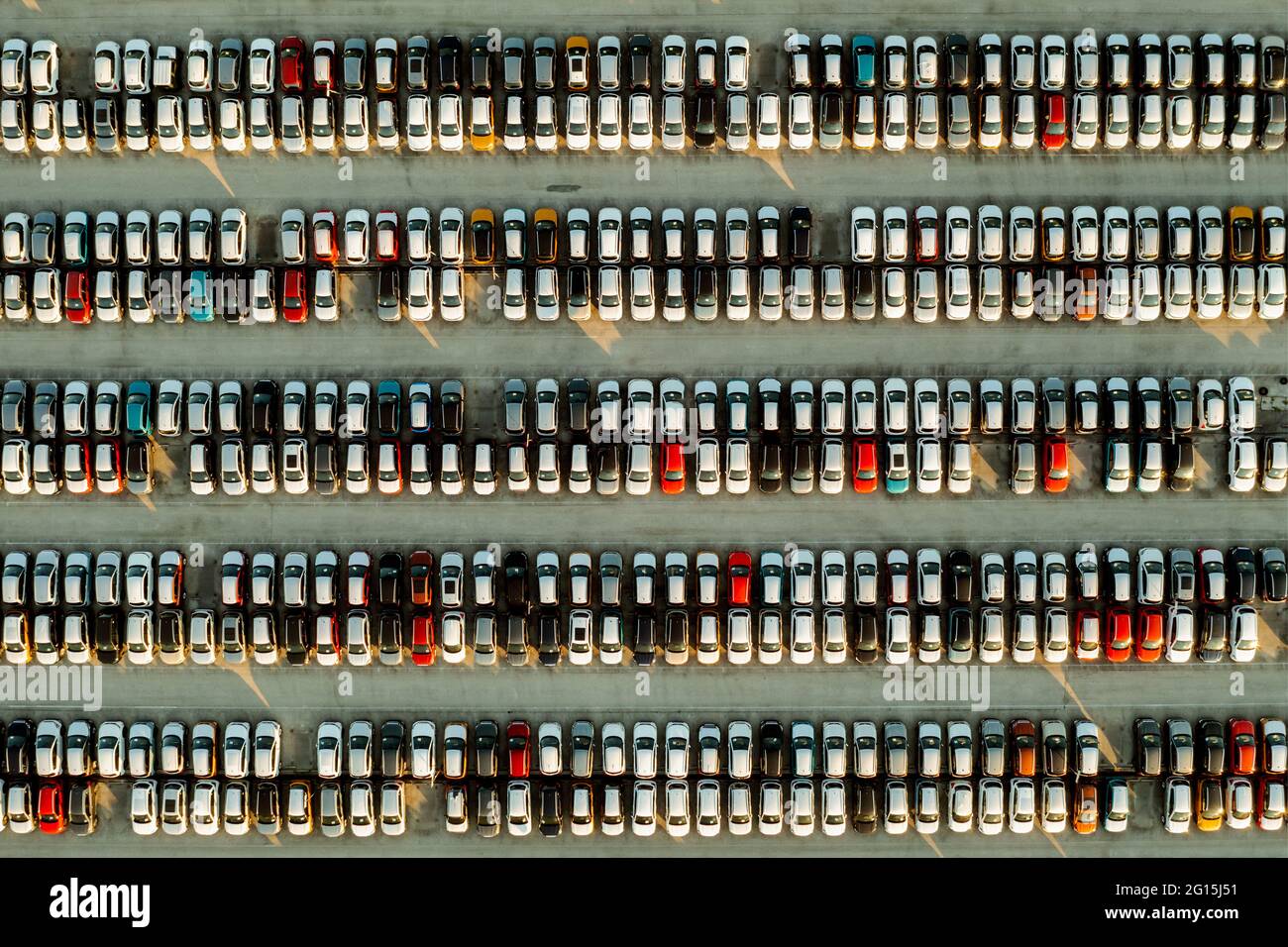 Aerial view new cars lined up in the parking station for import and export business logistic to dealership for sale, Automobile and automotive car par Stock Photo