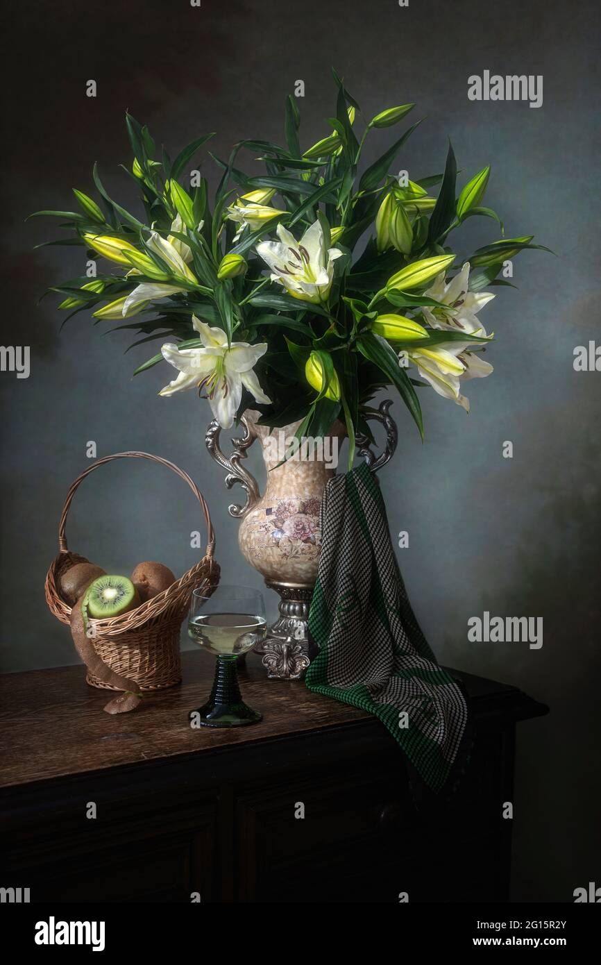 Still life with lily flowers and fruits Stock Photo - Alamy