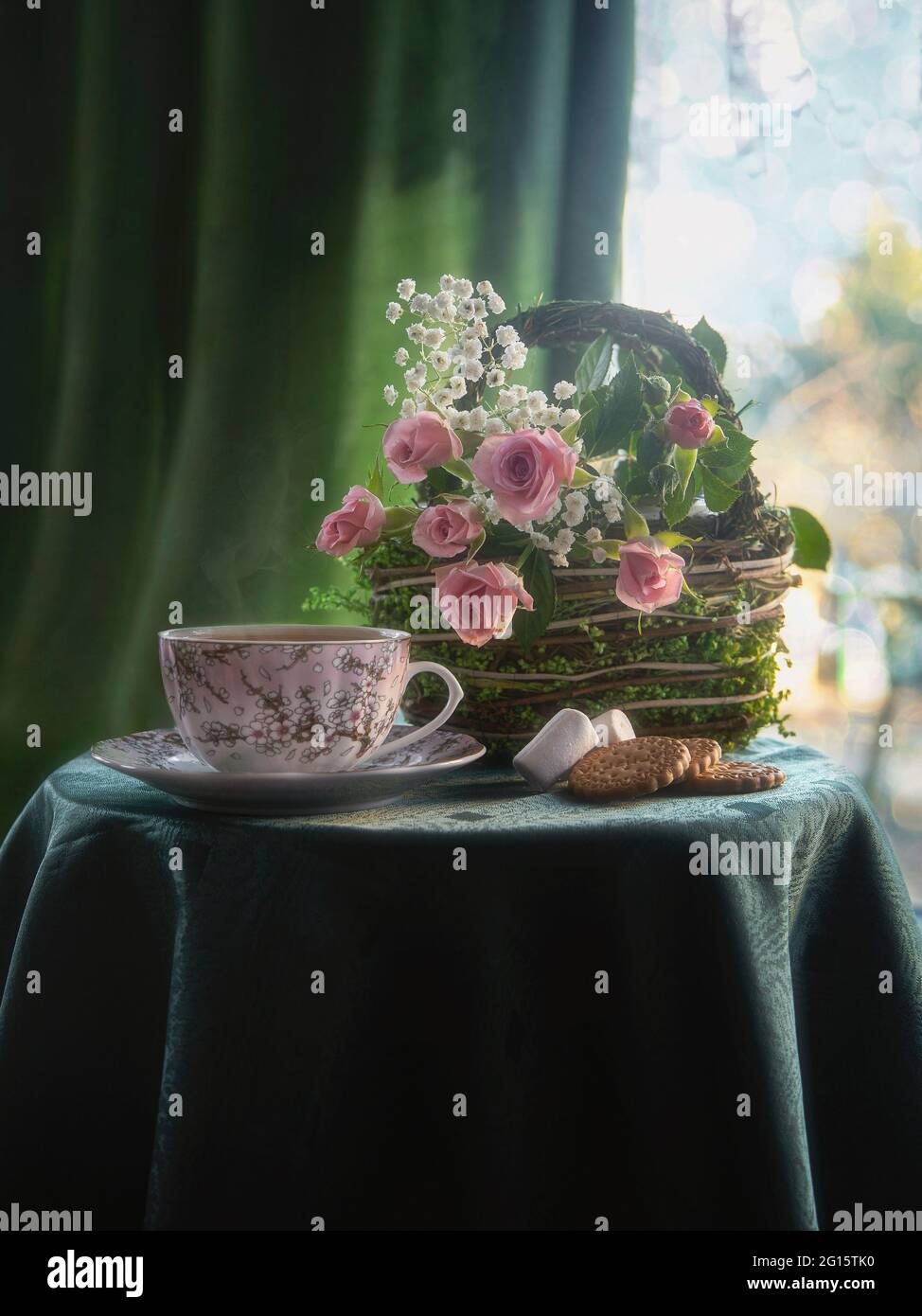 Still life with beautiful bouquet of flowers on a tea table Stock Photo