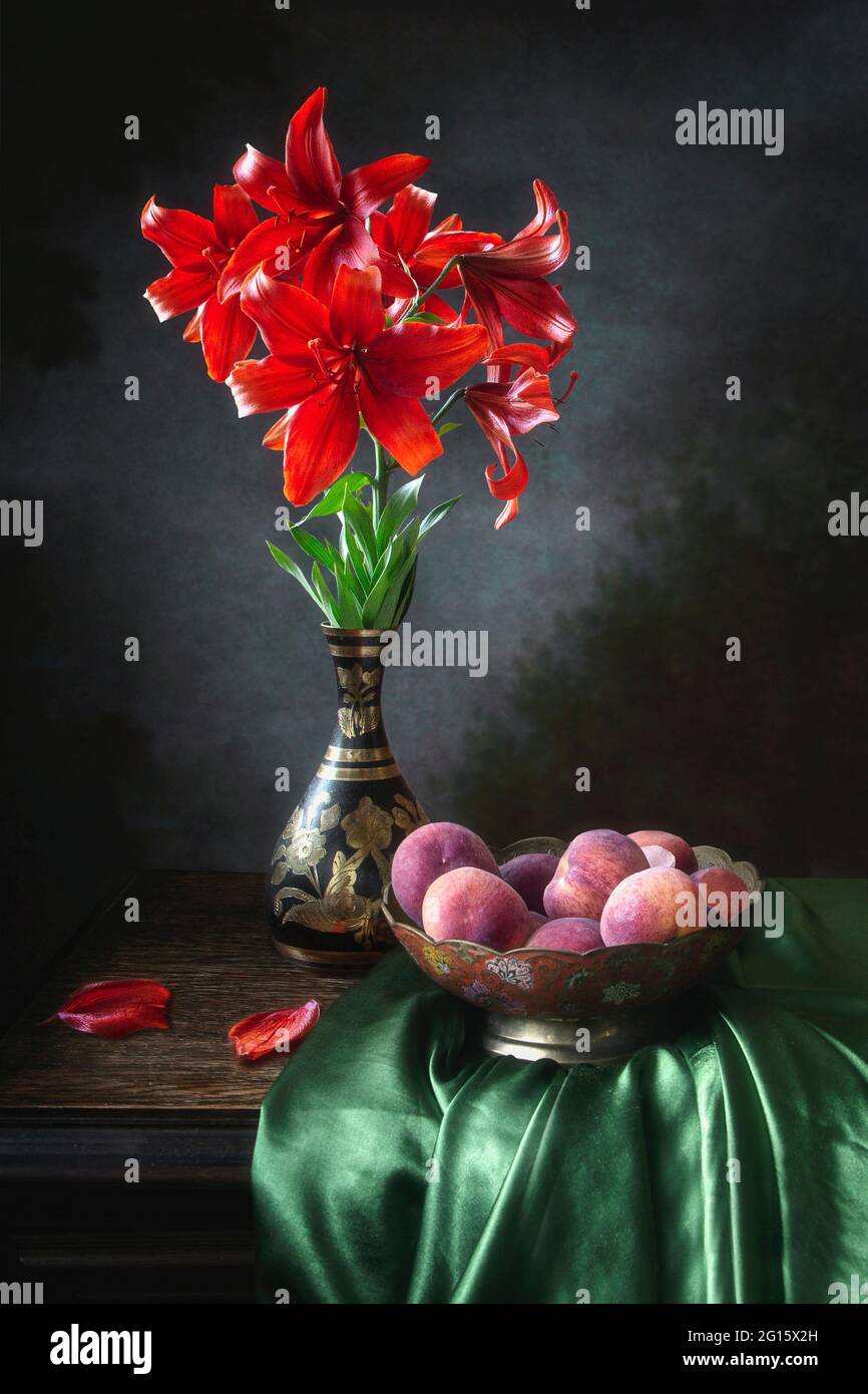 Still life with beautiful bouquet of garden lily and fruits Stock Photo ...