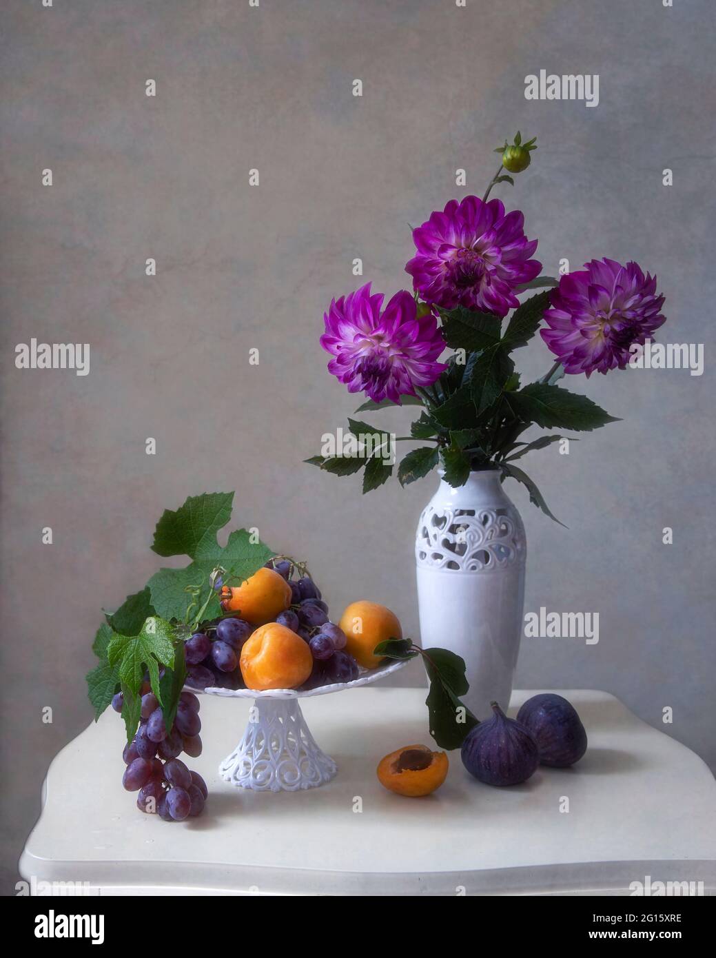 Still life with beautiful bouquet of flowers and fruits Stock Photo - Alamy