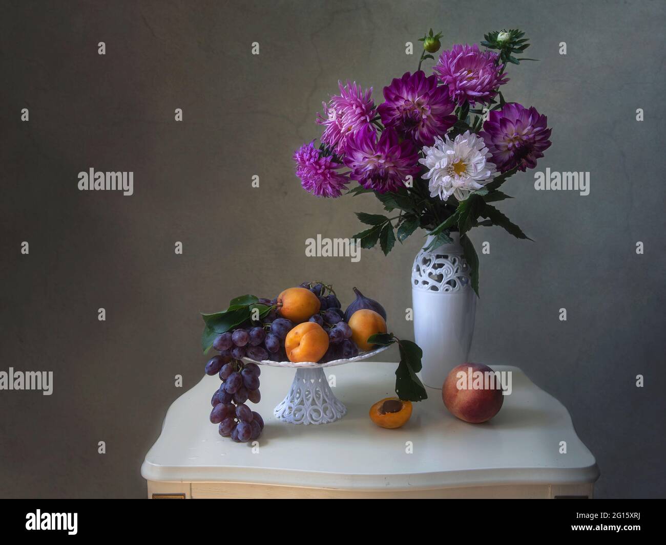 Still life with beautiful bouquet of flowers and fruits Stock Photo - Alamy